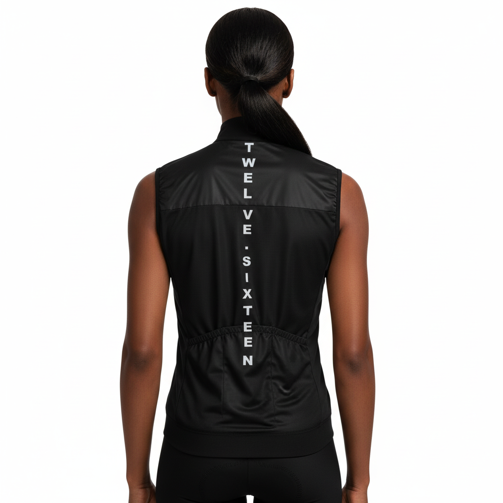 Black Wome's Gilet with 'TWELVE SIXTEEN' branding on the back, worn by a person.